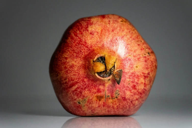 a red apple sitting on top of a table