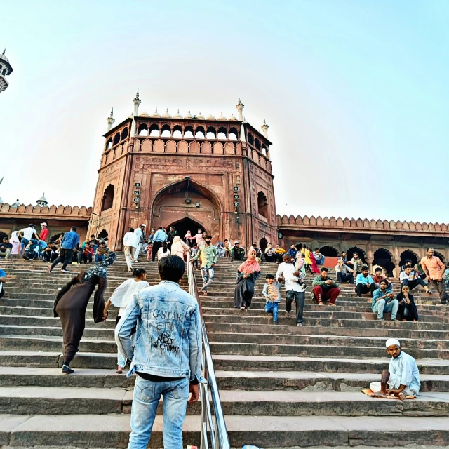 a man climbing the steps towards a building with a staircase