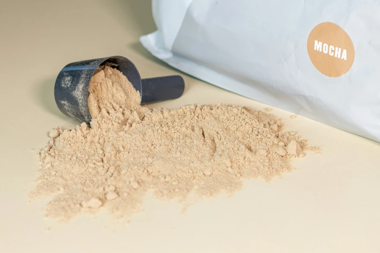 a pile of brown sand near a sand bag