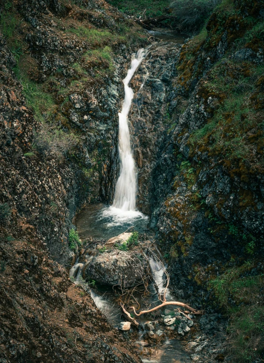 a waterfall with water that is cascading from the side