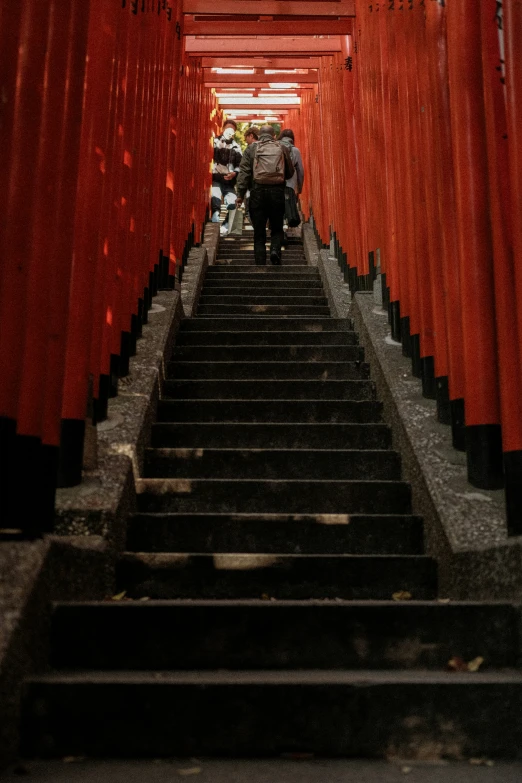 a man carrying a bag down some stairs