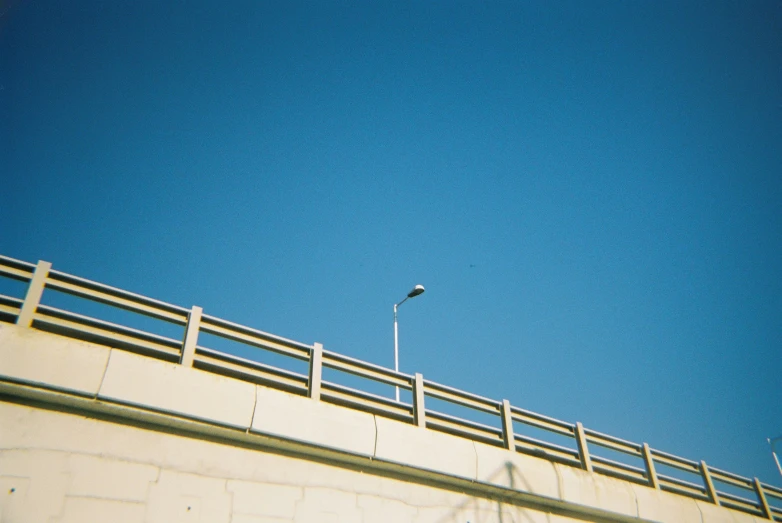 a bird is standing on a ledge near a lamp