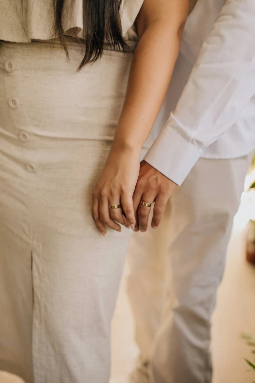 a close up of a couple holding hands