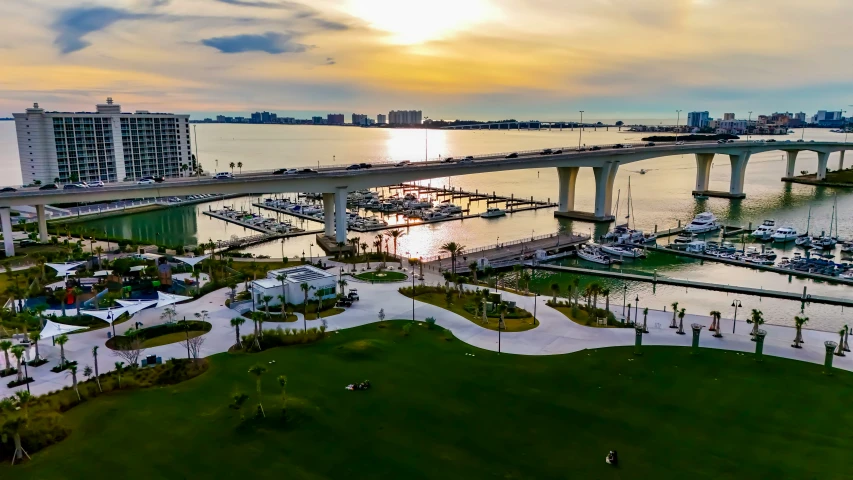 the sunset on the river, over an open space with boats in it