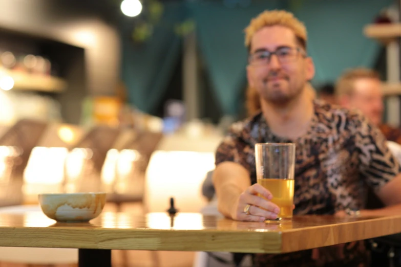 the man is enjoying his drink at the restaurant