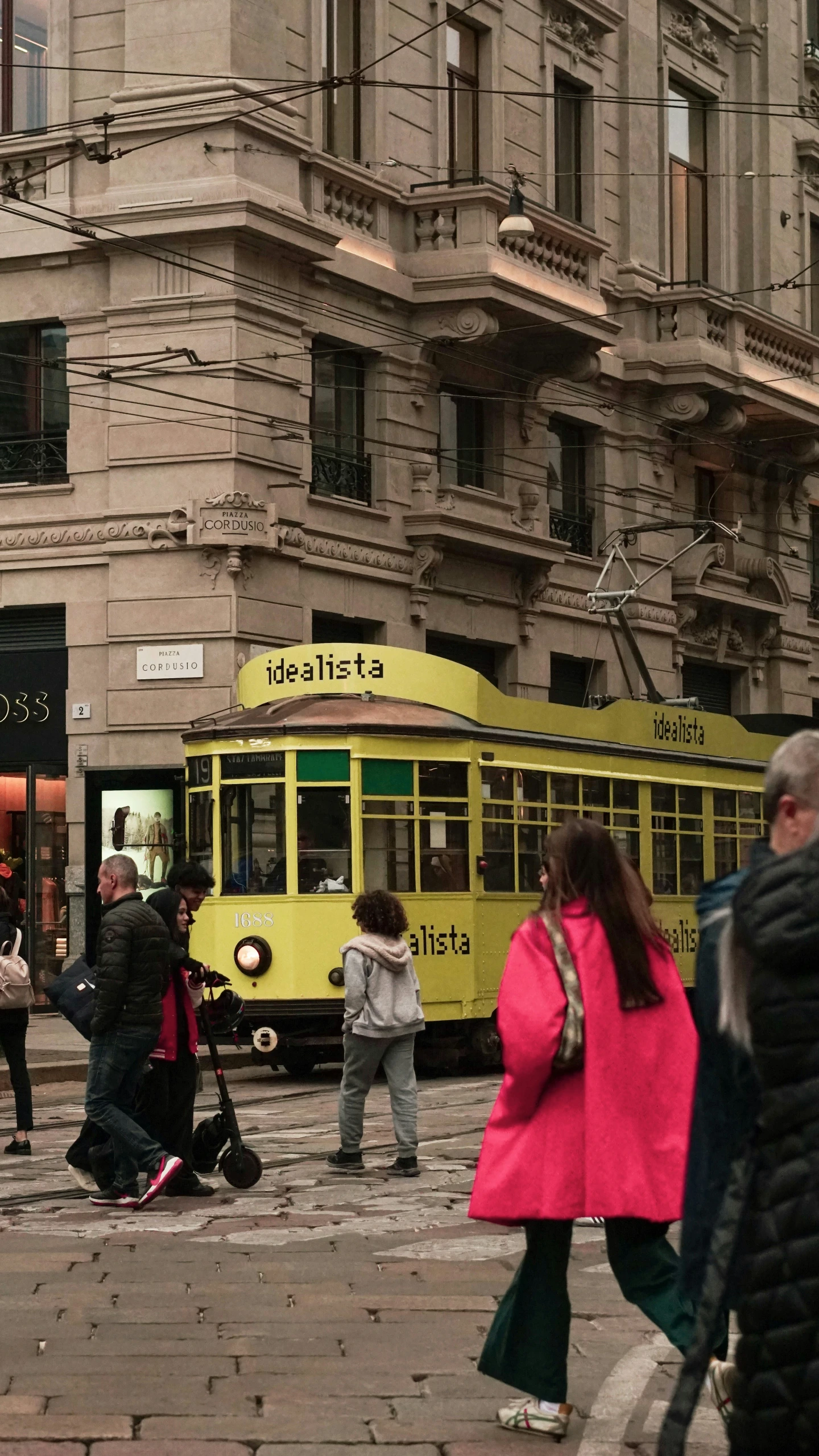 a yellow streetcar on the street of a city