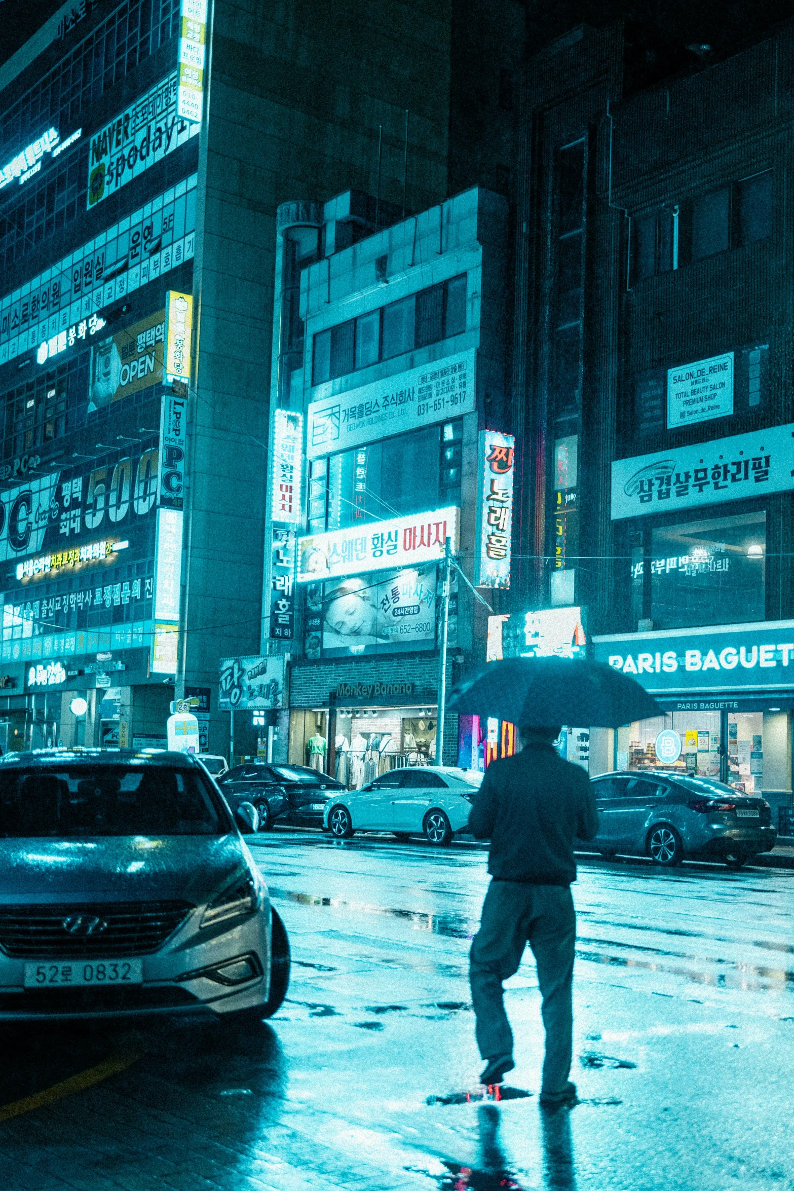 a man walking with an umbrella across the street