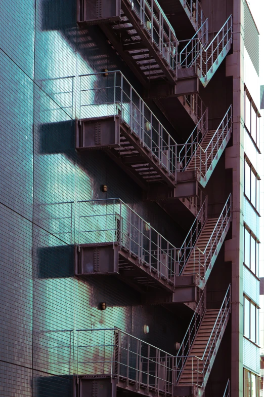 a group of fire escape stairs next to a building