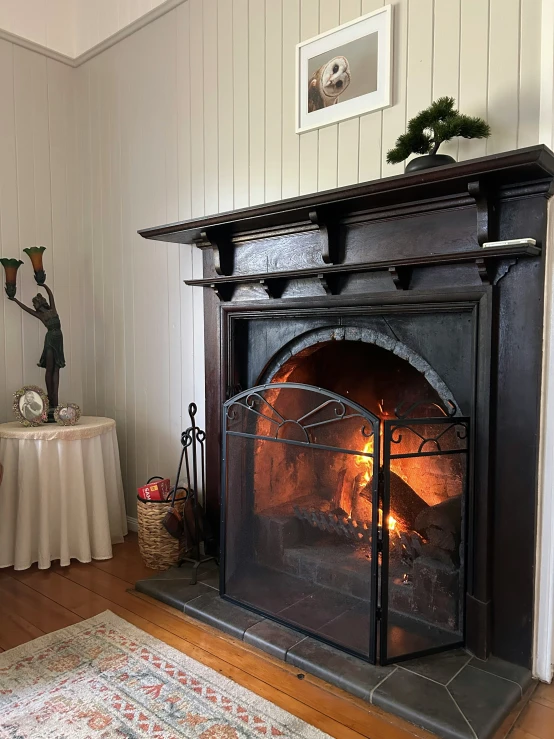 an old style fireplace in a white room with a rug