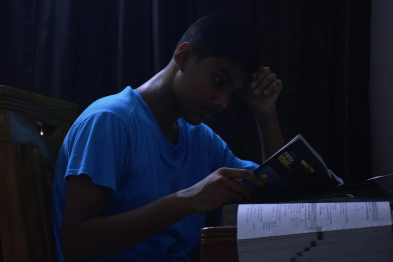 a man holding his head with his hands as he uses his phone