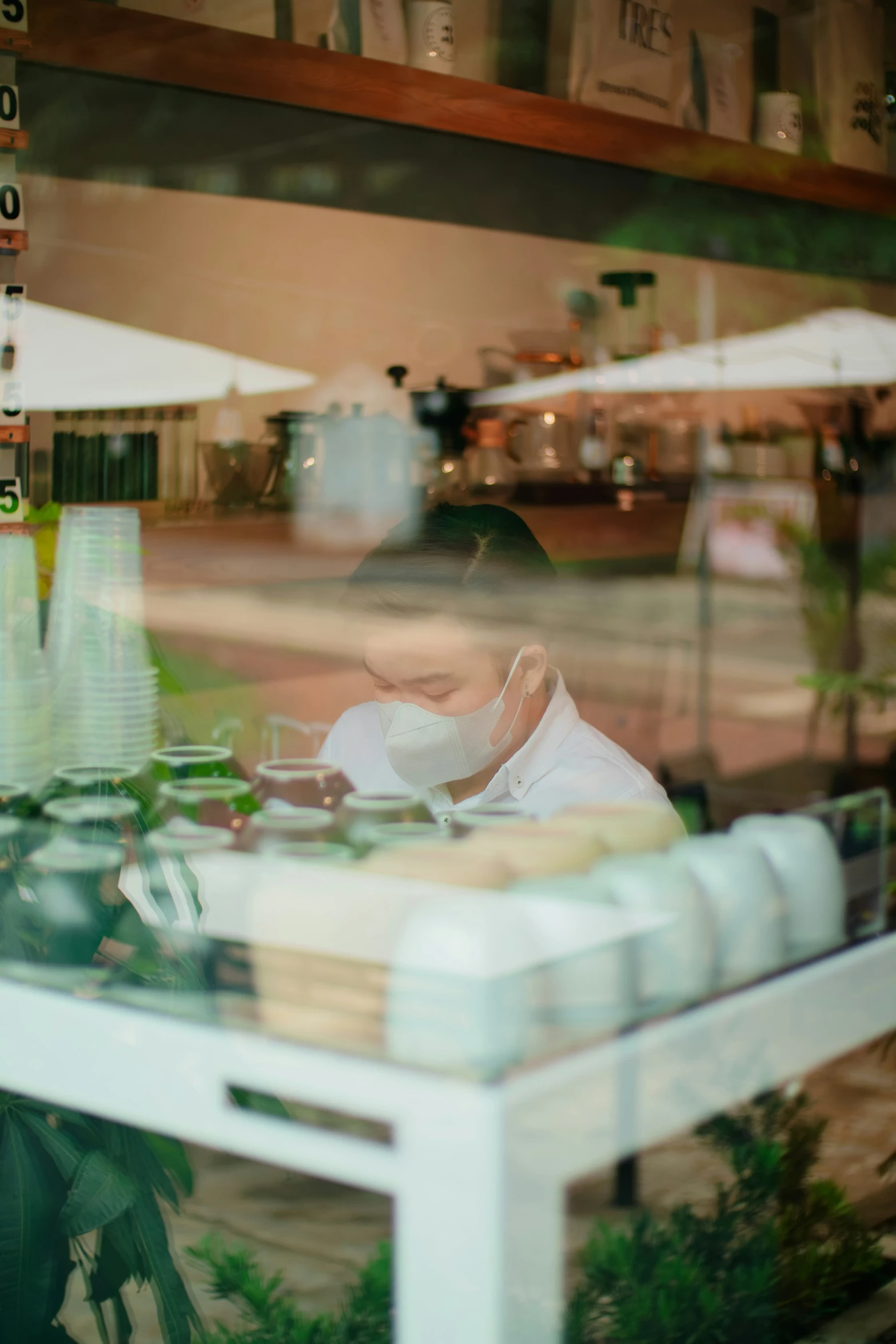 a man is working on soing while sitting in a chair in front of a window