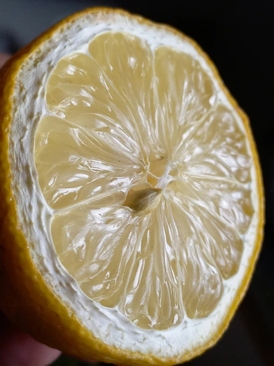 there is a slice of lemon being sliced in half