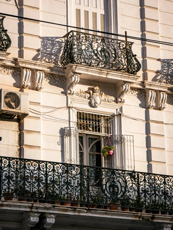 an old building with ornate iron balcony railings