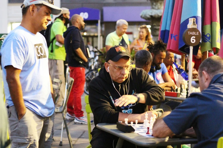 an older man blowing out candles for people to enjoy