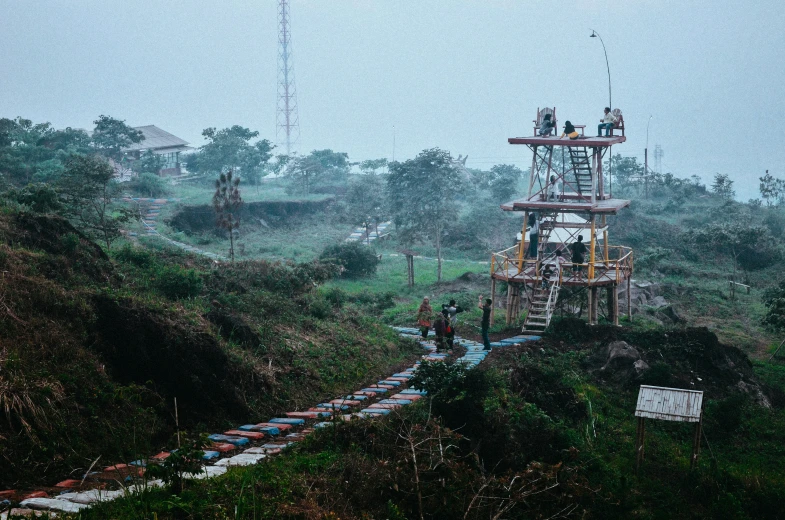 a large tower of machinery sitting in a lush green hillside