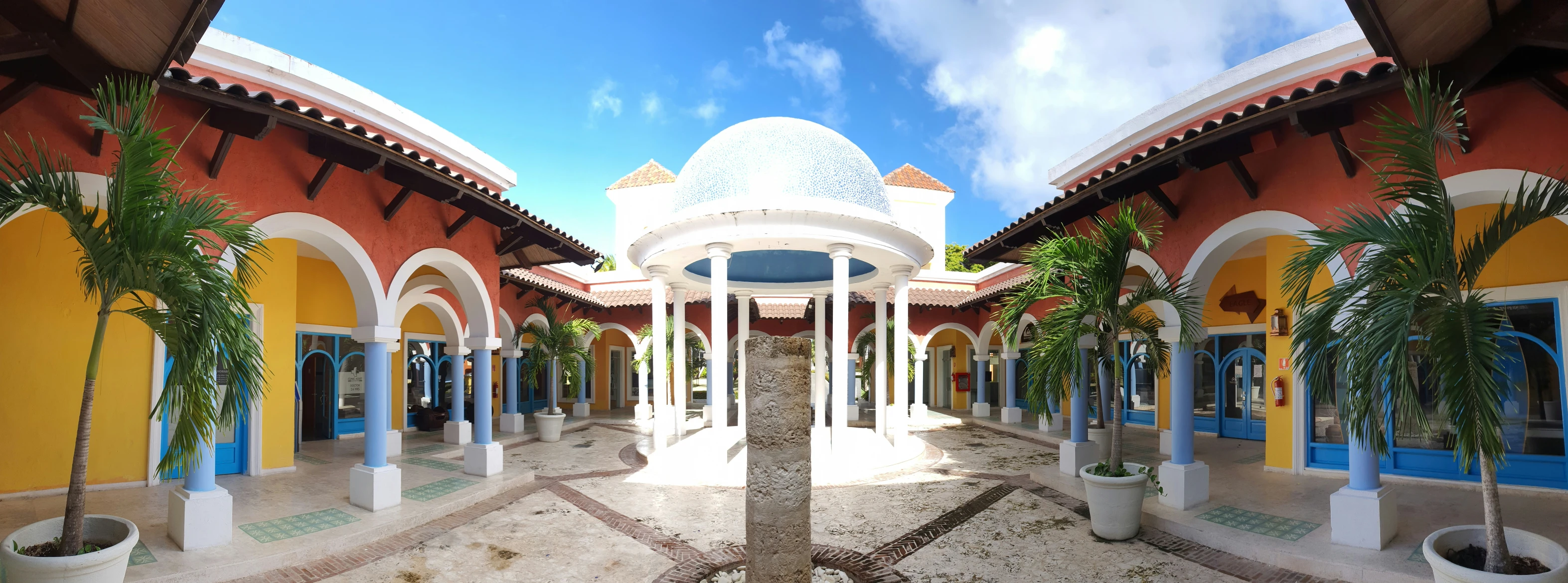 a courtyard area with a bunch of columns and arches