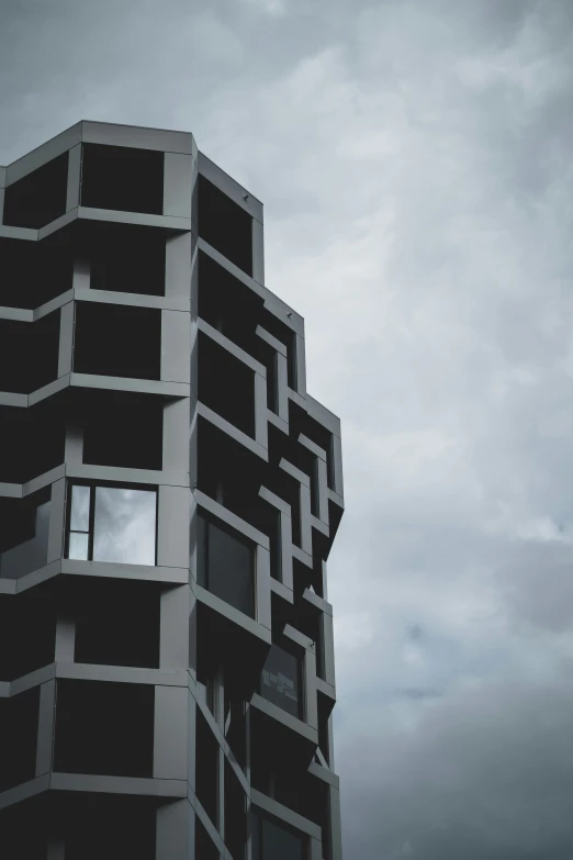 an image of an unusual building with dark clouds