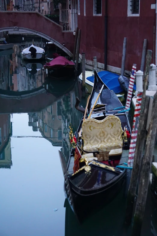 a couple of boats parked near a dock with umbrellas