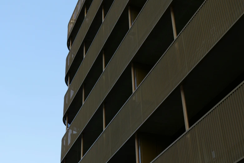 an airplane flies above a brick wall under a blue sky