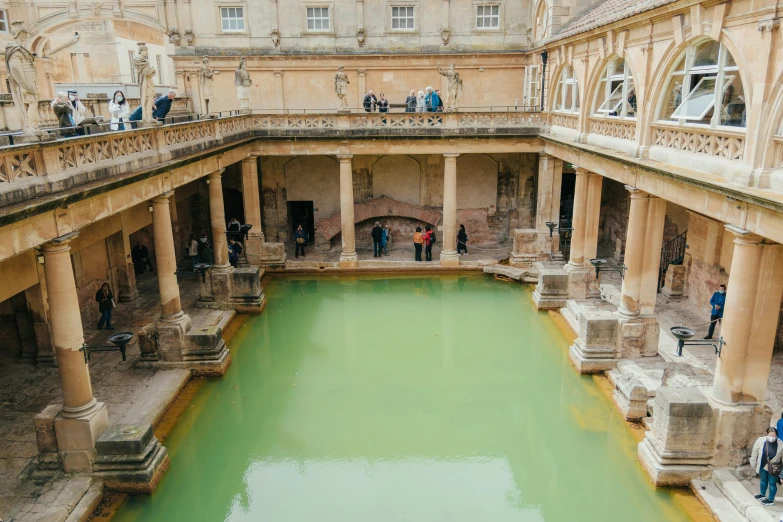 people standing in a pool inside a building