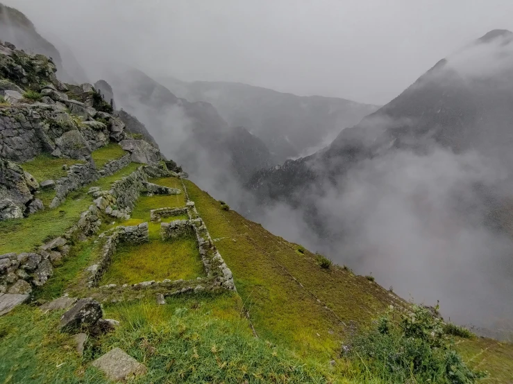 an image of some mountain side with mist