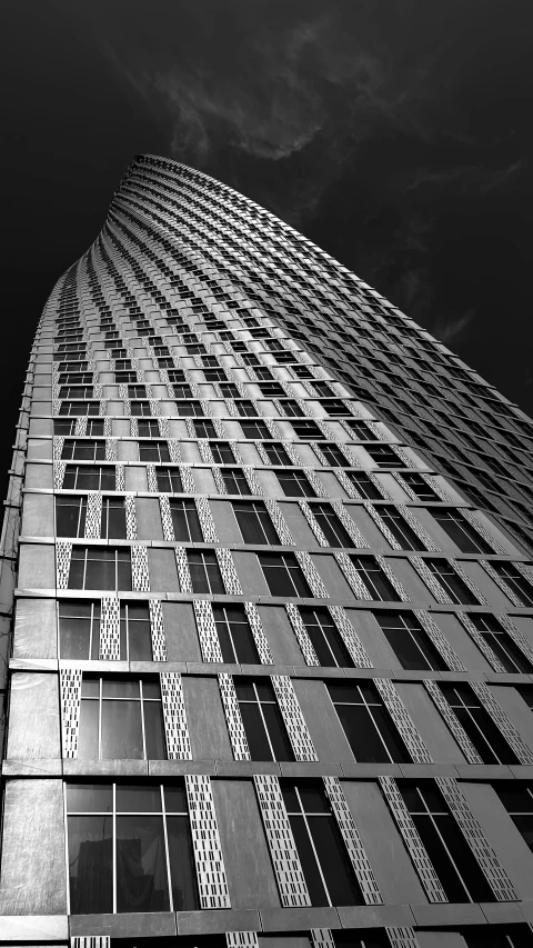 the side of a tall building with windows on it