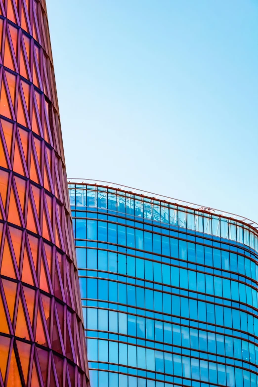 modern glass building with a triangular roof in front