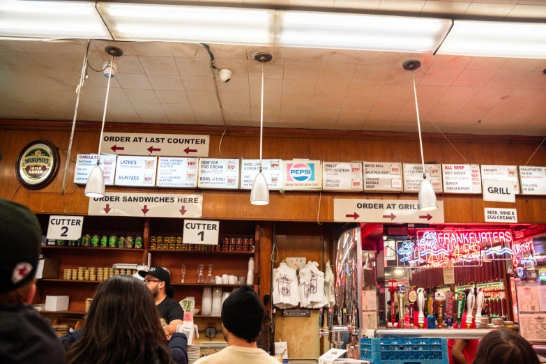 a group of people standing in front of a bar