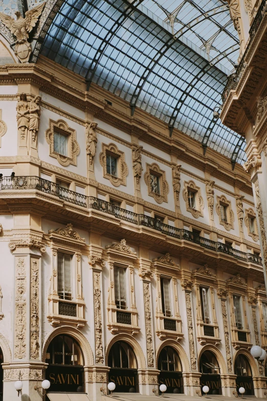 a building with two windows and a ceiling filled with glass