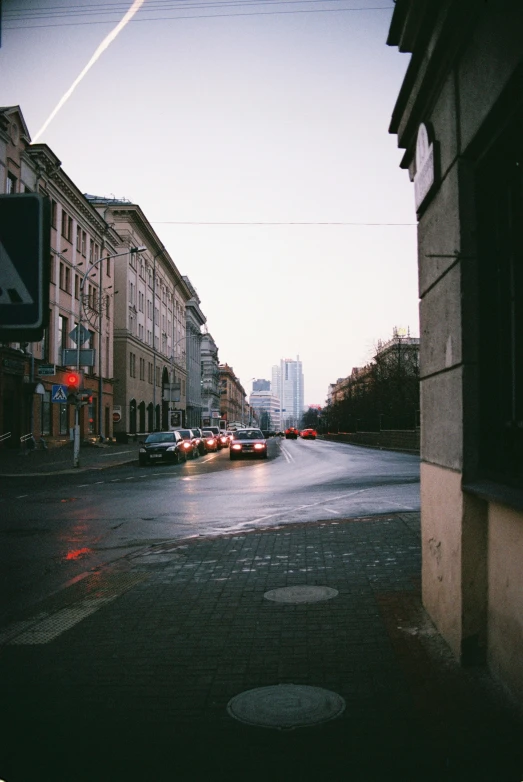 a rainy day on a street filled with parked cars