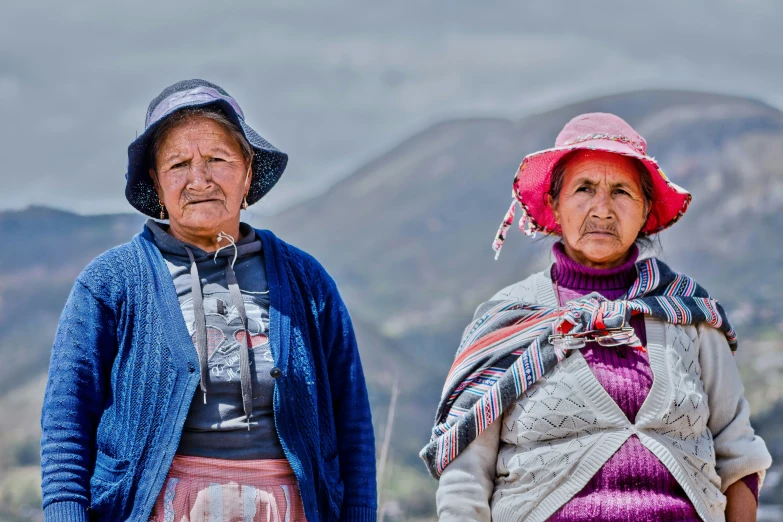 a couple of older women wearing hats and scarves