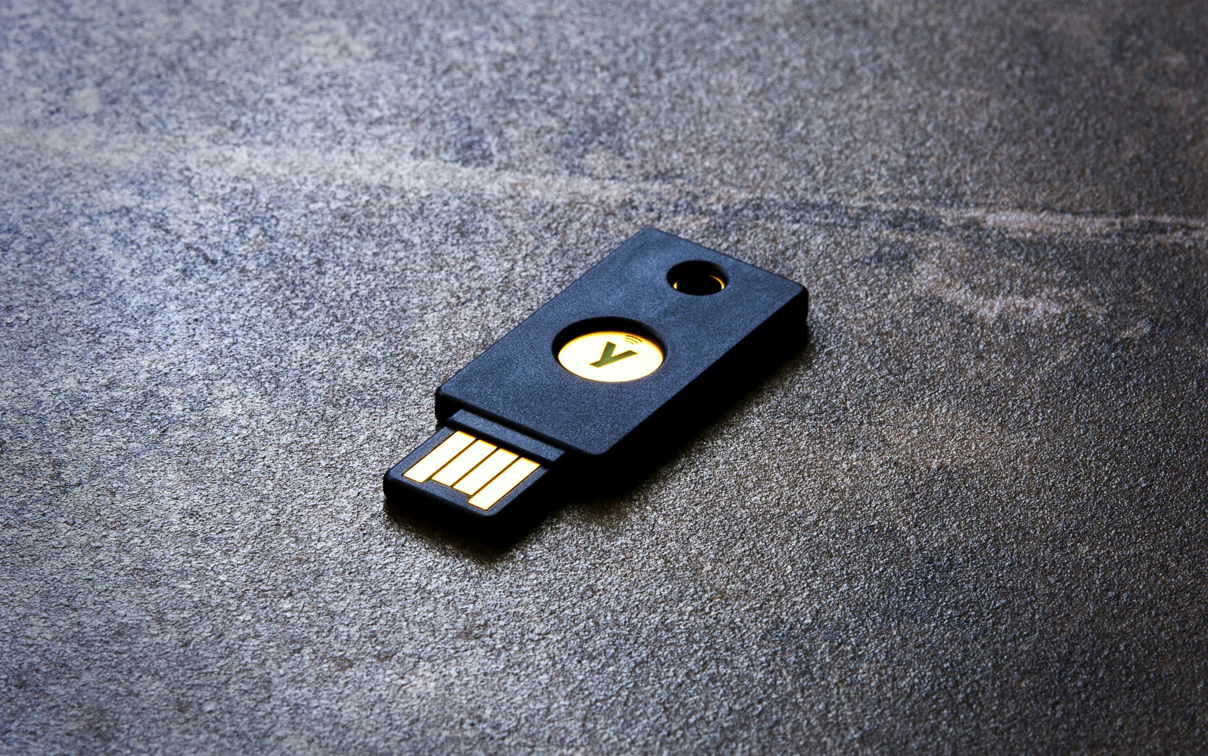 an electronic key sitting on a blue surface