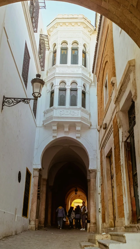 a large archway in a building next to some buildings