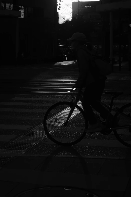 a man riding a bike at night in the dark