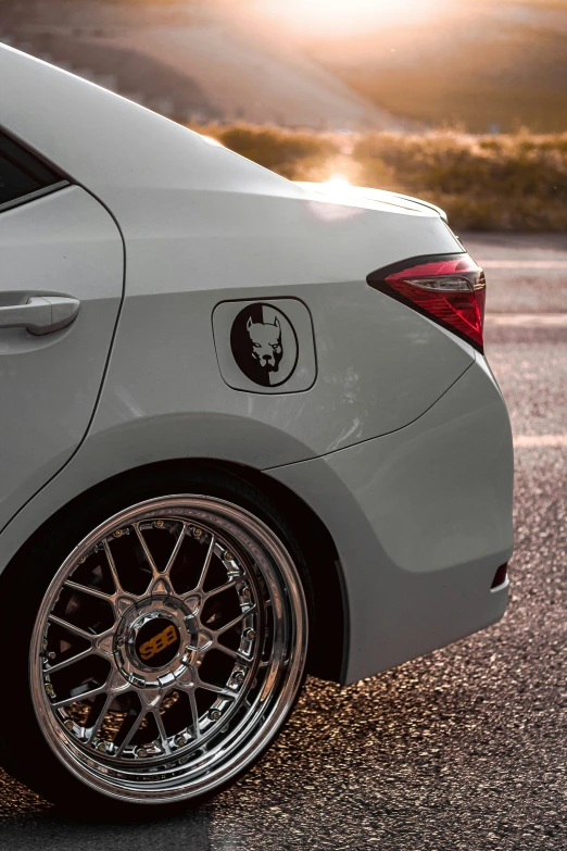 silver sports car parked on concrete at sunset