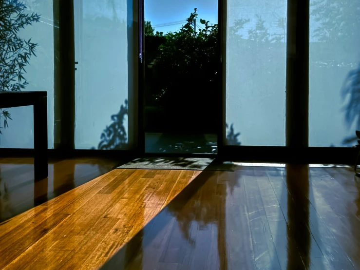 a wooden bench sitting in front of an open window