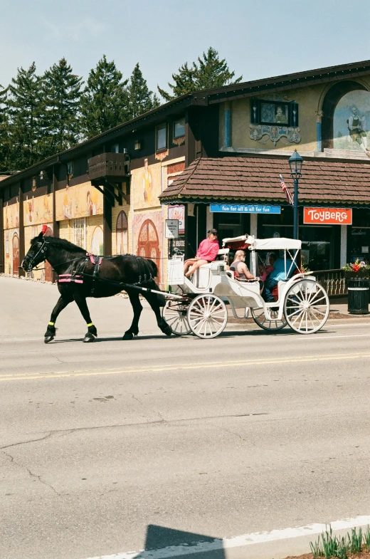 a horse and carriage pulling people on the street