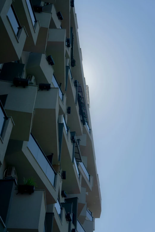 a view of the sky from behind an apartment block