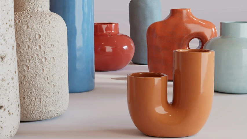 several different colors and sizes vases sitting on a table