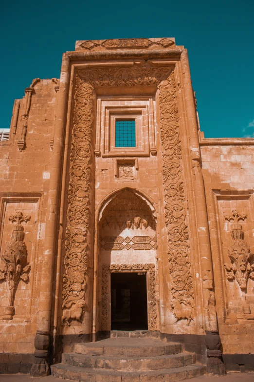 a red stone building with a staircase leading up to it