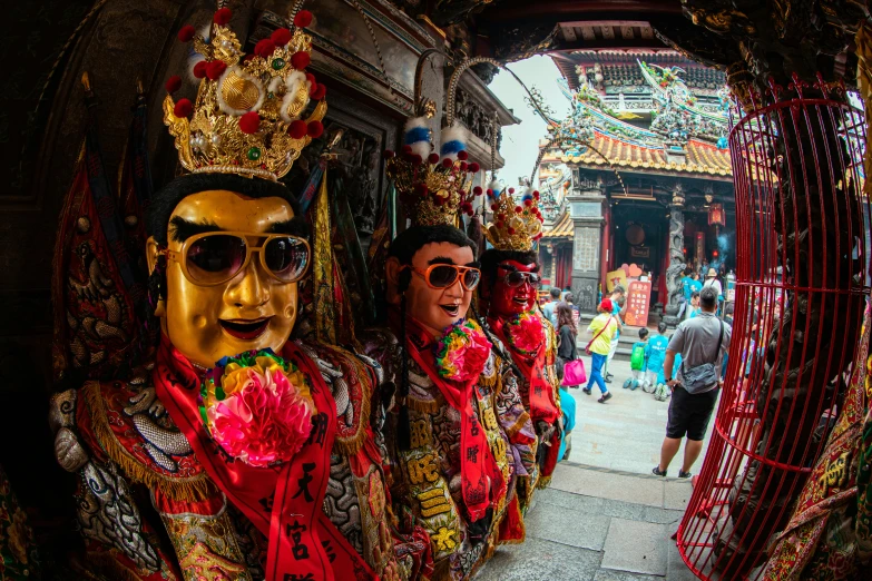 a group of people with fake masks in front of a building