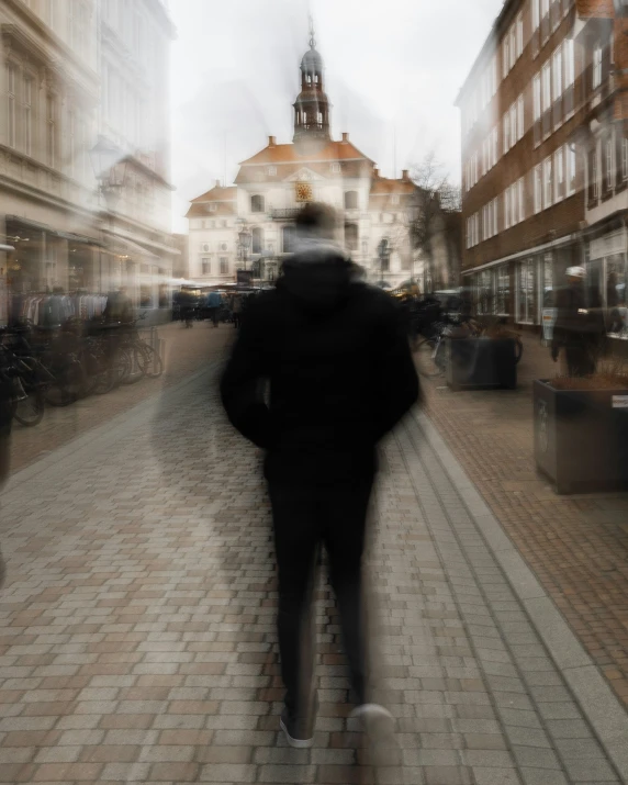 blurry pograph of a person walking in an old european town