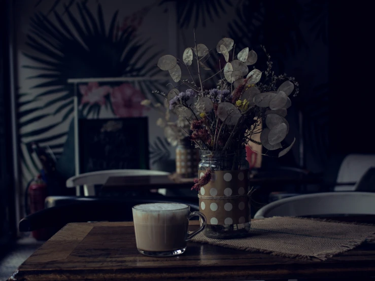 vase full of flowers sitting on a table