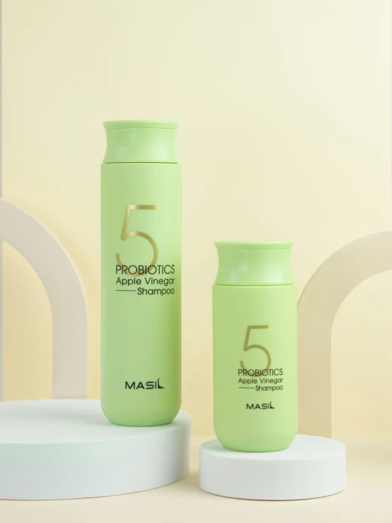 a bottle with the number 5 next to it and another container on a stand