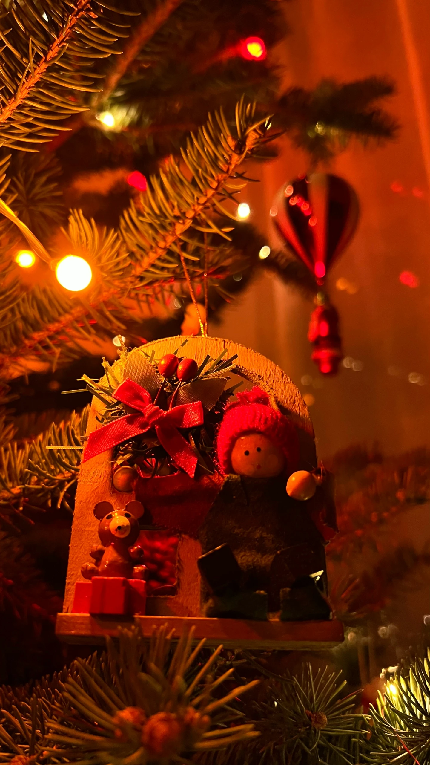 a christmas tree is decorated with two ornaments