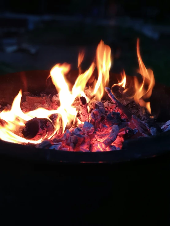 a close up of a fire pit with flames