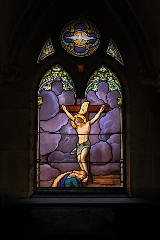 the stained glass window in this church depicts christ nailed up