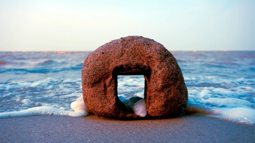 a very strange object on a beach with some water