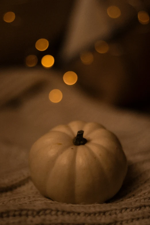 an empty white pumpkin is sitting on a bed