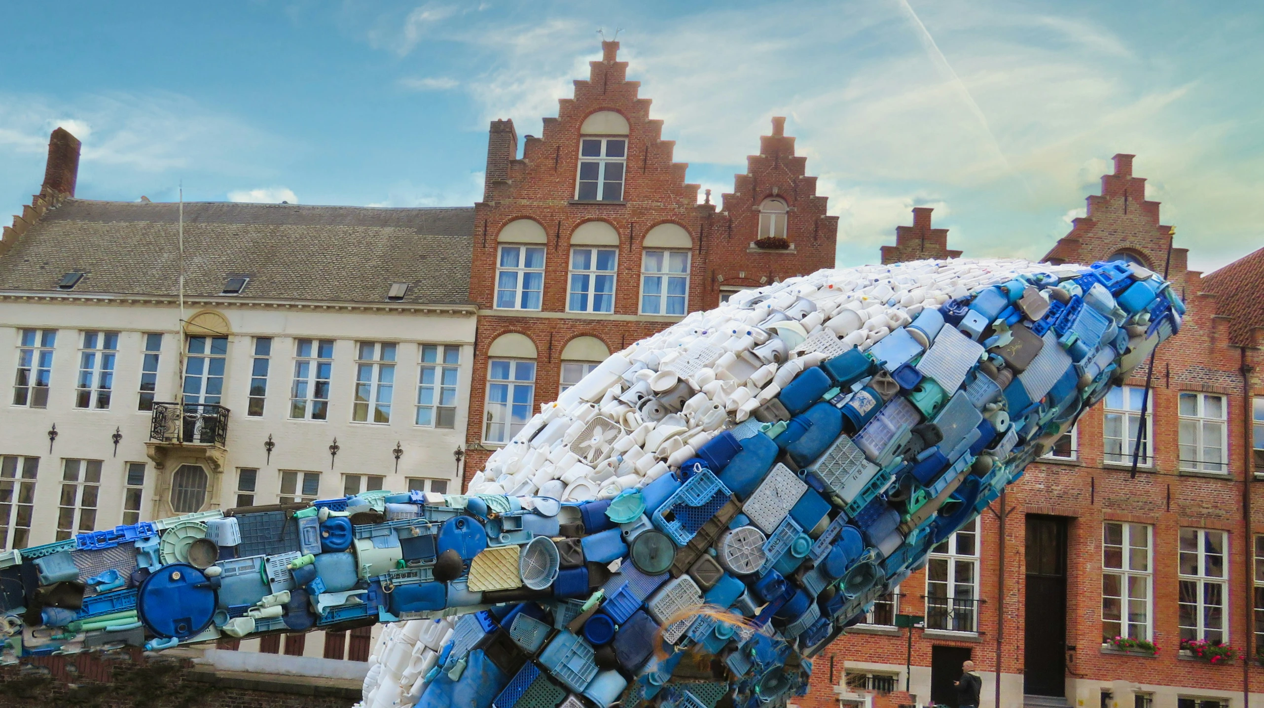 a sculpture of glass is standing in the street